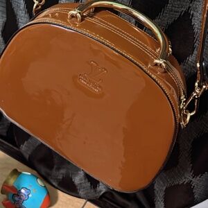 Lv embossed patent leather hand bag